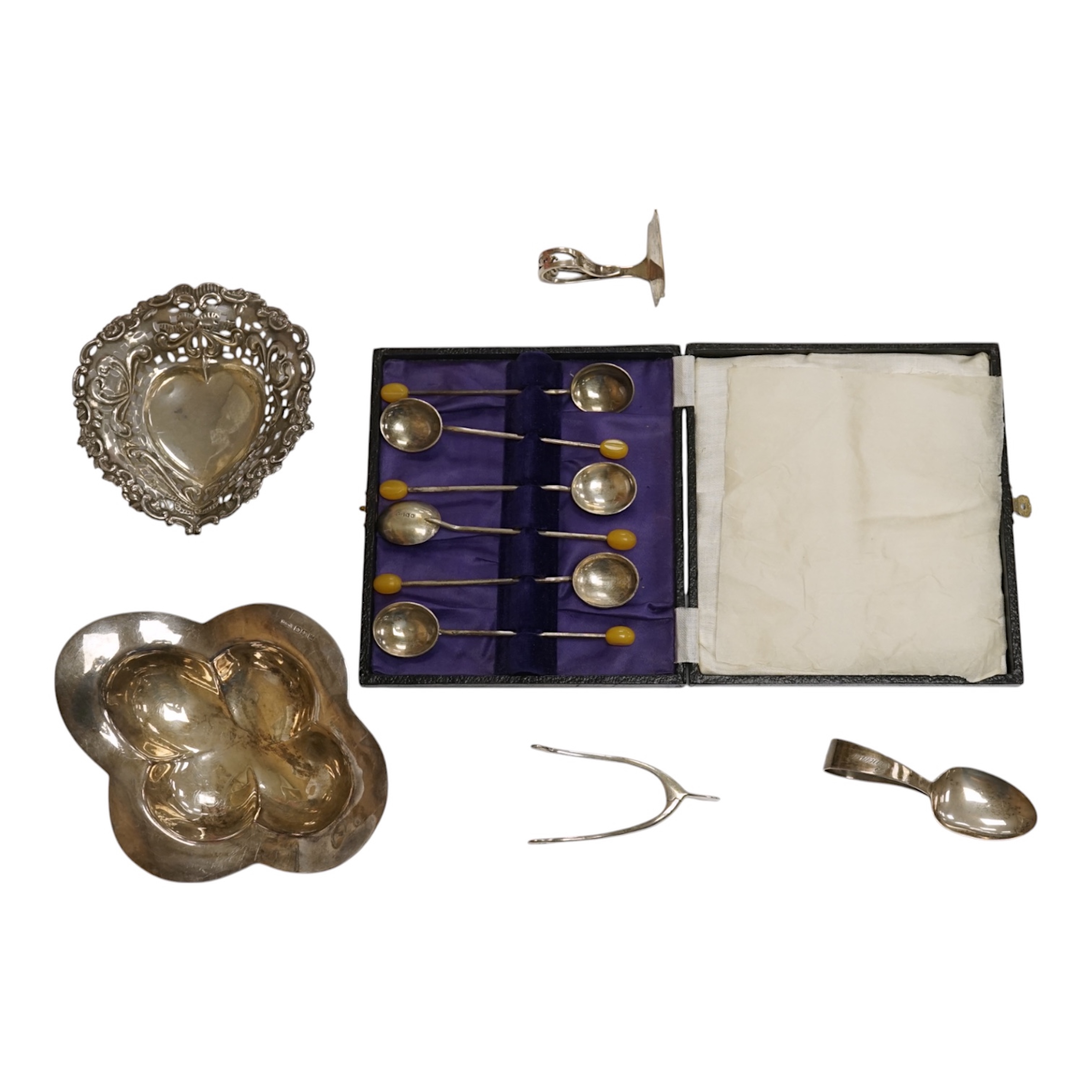 An Elizabeth II silver quatrefoil dish by James Dixon & Sons, Sheffield, 1967, 14.2cm, together with a silver spoon and pusher, silver bonbon dish, pair of silver wishbone nips and a cased set of plated spoons. Condition